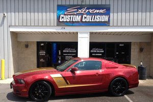 front shop photo of Extreme Custom Collision with red car in the center
